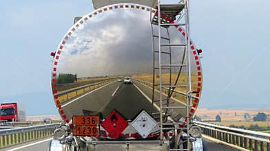 Reflection of road and sky in chrome tank truck on the A1 highway, Spain