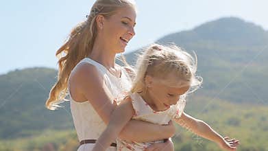 Close up of young mother circling her little