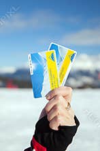 Woman hand holds two skipass