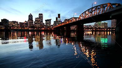 Downtown City Skyline of Portland Oregon along Willamette River with Hawthorne Bridge and Blue Hour Water Reflection Ripples
