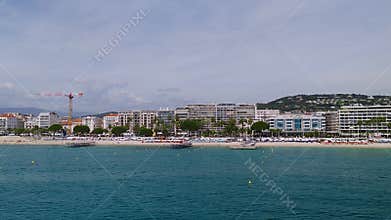 Aerial pan along Cannes La Croisette with Carlton and Palais venues