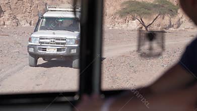 Off-road safari cars driving through the egyptian desert