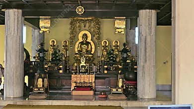 Interior of a Buddhist temple featuring a golden Buddha statue