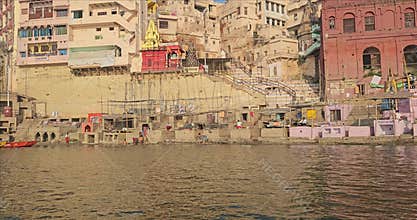 Riverside view of Varanasi ghats from moving boat on Ganges River