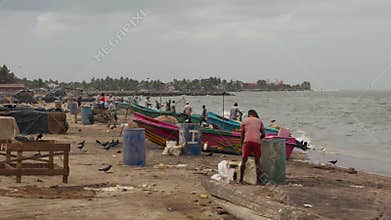 Fishermen unload their catch from old boats, editorial video