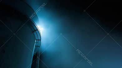 Industrial silo at night in mysterious blue atmosphere