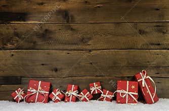 Wooden rustic background with red christmas presents.