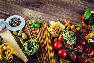 Italian and Mediterranean food ingredients on old wooden background.