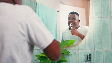 Happy Black Man Brushes Teeth in Bathroom Mirror, Practicing Oral Hygiene with a Radiant Smile