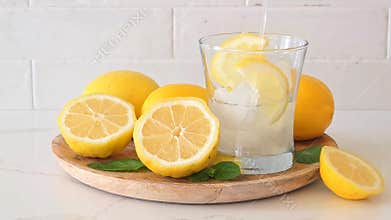 Pouring of a glass of refreshing summer lemonade