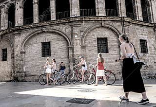 People going about their daily lives in the streets of the city of Valencia