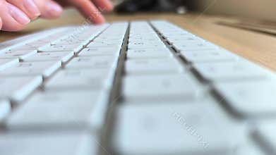 Side view of fingers pressing keyboard keys. Hands typing text