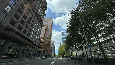 Modern high rise office towers and residential buildings along wide city street