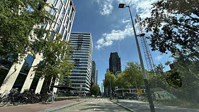 Modern office towers and tree lined urban street in Amsterdam Zuid with