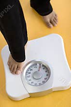 Woman stepping on scale