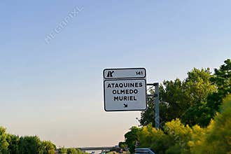 Road sign on the A6 motorway , exit 141 towards Ataquines, Olmedo and Muriel , Spain