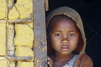 Shy and poor african girl with headkerchief