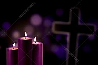 Purple candles with a cross symbol