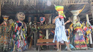 Asian thai woman wearing mask head with costume of Phi Ta Khon dance and playing