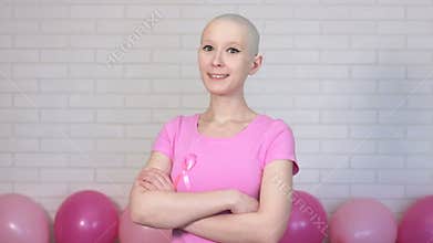 Confident breast cancer survivor woman looking crosses her arms looking at the camera and smiling - breast cancer
