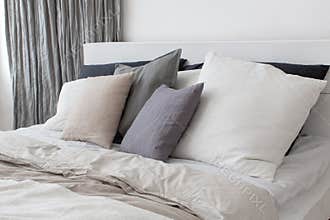 Bed with white and grey linens