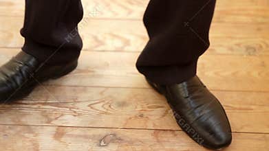 Legs of a young man in the dancing shoes