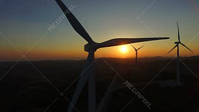 Close up of rotating windmill blades at sunset
