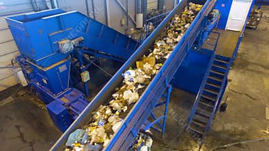 Waste sorting. Factory conveyor working at a recycling plant.