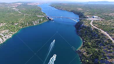 Aerial view of speedboats approaching bridge over dalmatian canal, Croatia