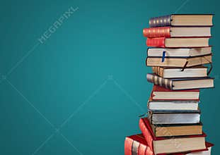 Pile of books against teal background