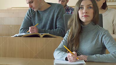 Students write in their exercise books