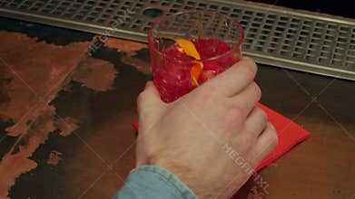 Male hand paying for a cocktail