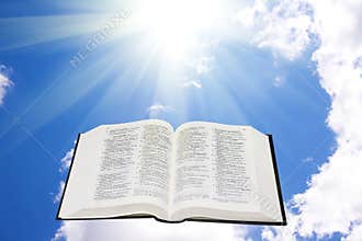 Holy bible in the sky illuminated by a sunlight