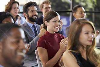 Audience applauding at a business seminar, close up