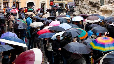 Italy, Rome - September 2016: Crowd with umbrellas is standing near Trevi fountain.