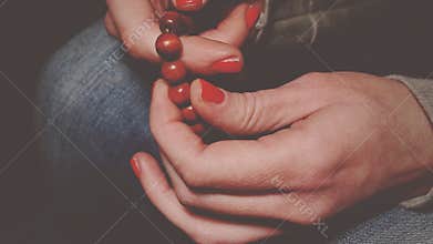 Praying hands with rosary cross.
