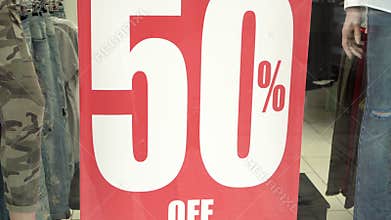 Big red sales sign in a shop window. 50 percent sales. Promotion. Consumerism concept.