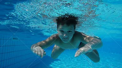 Boy in swimming pool swim underwater