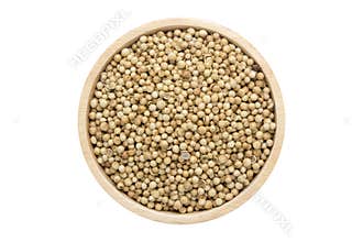 Coriander seeds in wooden bowl isolated top view on white