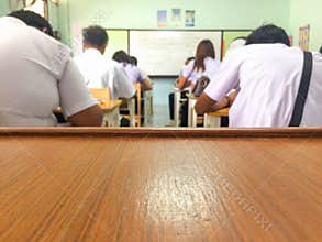 Space on table for greeting text and object with blur classroom background.