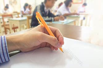 Students studying and testing the final examination in classroom.