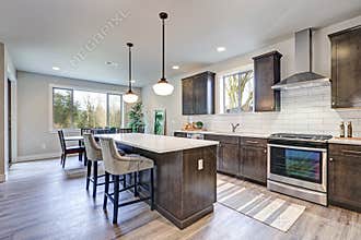 New kitchen boasts dark wood cabinets, large island