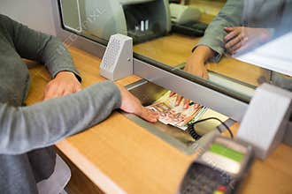 Clerk giving cash money to customer at bank office
