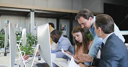 Businessman come to help business people deal with documents working in creative office space, colleagues teamwork