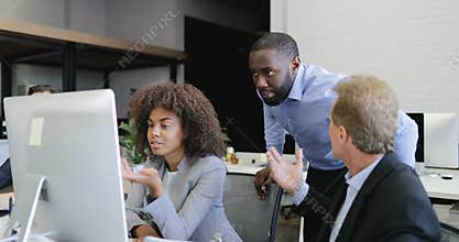 Business people group working together on computer talking modern coworking office with businesspeople team discussion