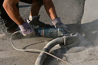 Grinding rough edges of concrete on a curb and road