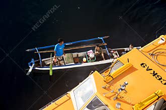 Indonesian Fisherman selling freshly fished fish directly from boat