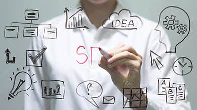 Woman writing SEO on transparent screen. Businesswoman write on board.