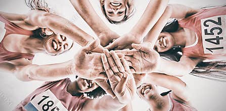 Five smiling runners supporting breast cancer marathon