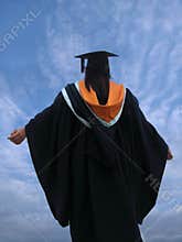 Graduate raising arms